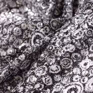 Materiał cekinowy, cekiny transparentne z akcentami czerni, drobne oczka, koła